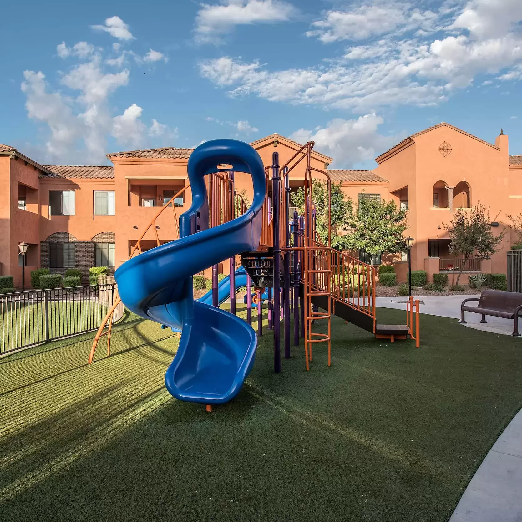 A playground with a slide for the children in the apartment community.