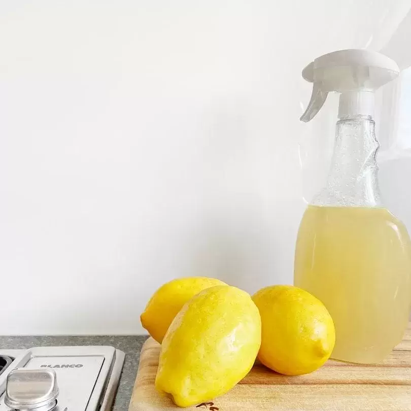 Eco-friendly cleaner on a counter with lemons