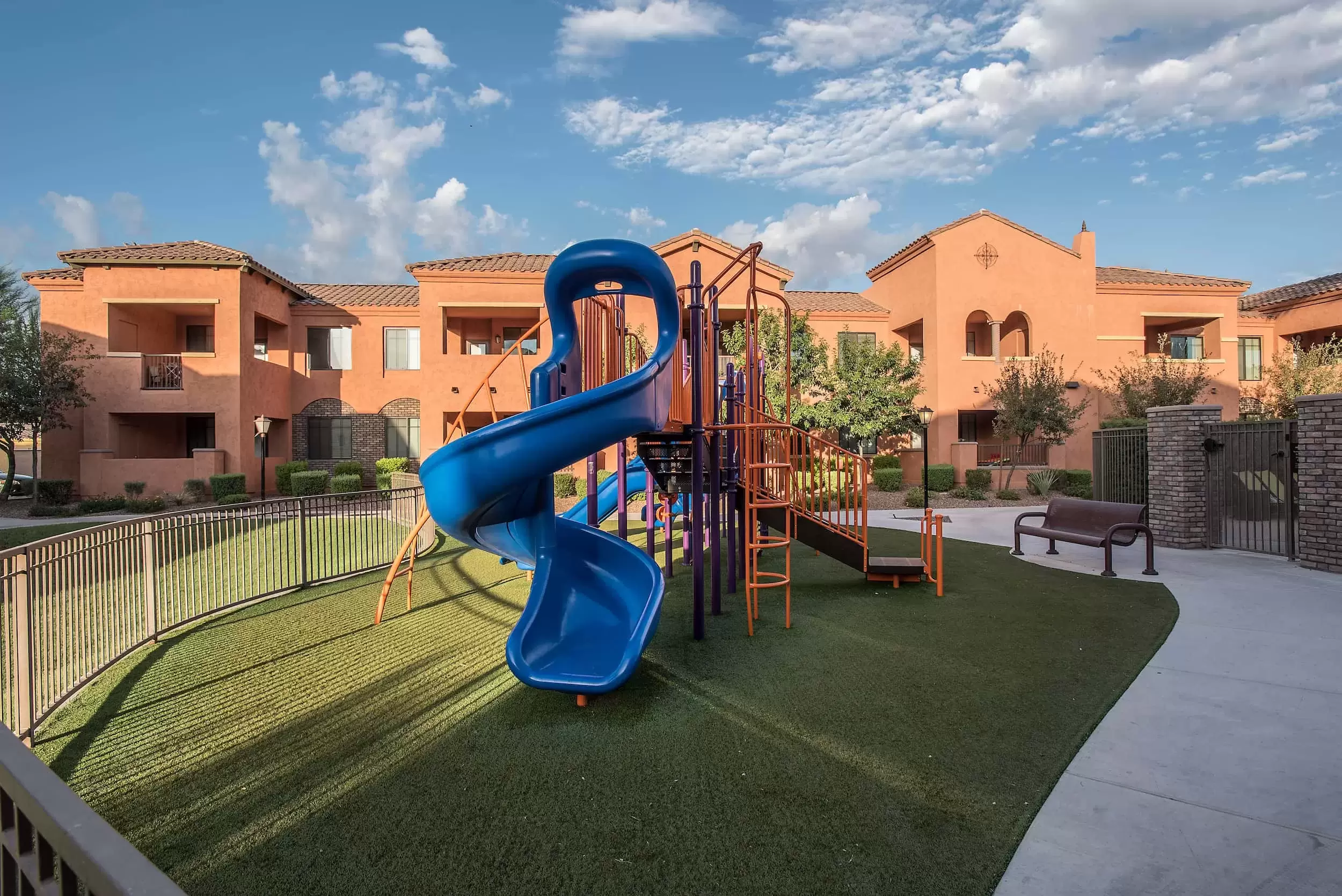 A playground with a slide for the children in the apartment community.